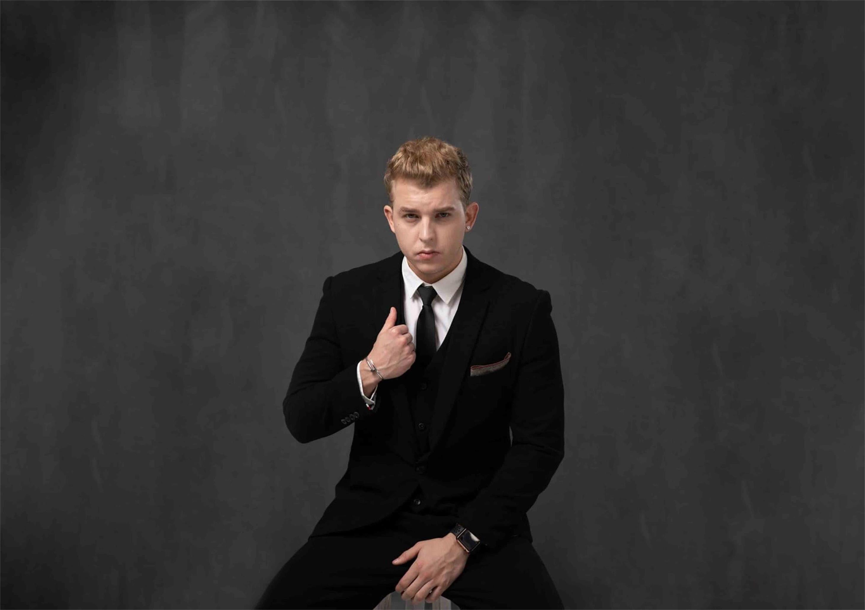 Full length portrait of a handsome serious man dressed in a jacket posing  while standing and looking at camera isolated over gray background Stock  Photo - Alamy