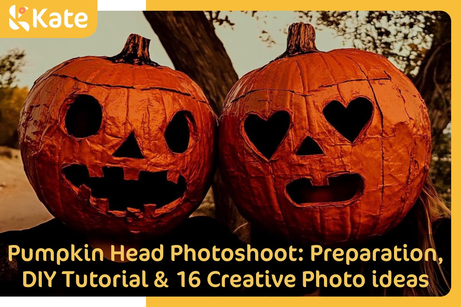 Two people wears large carved pumpkins.