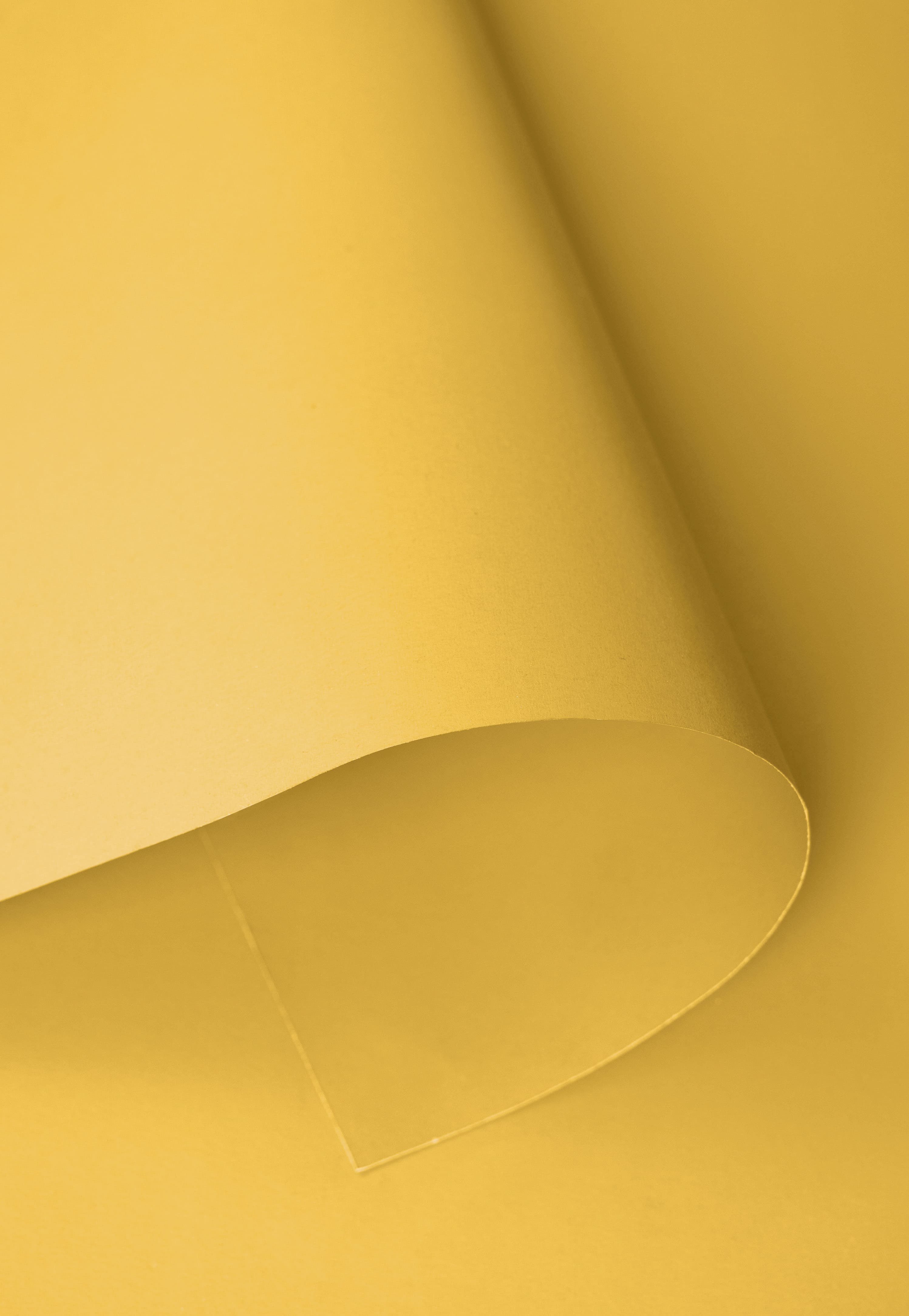 Fondo de papel liso amarillo claro para fotografía