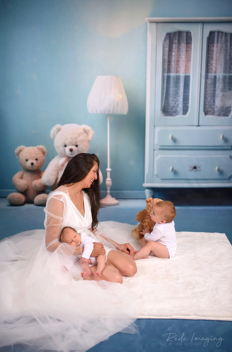 Lámpara blanca, armario azul, oso de peluche y fondo de pared floral diseñado por Lidia Redekopp