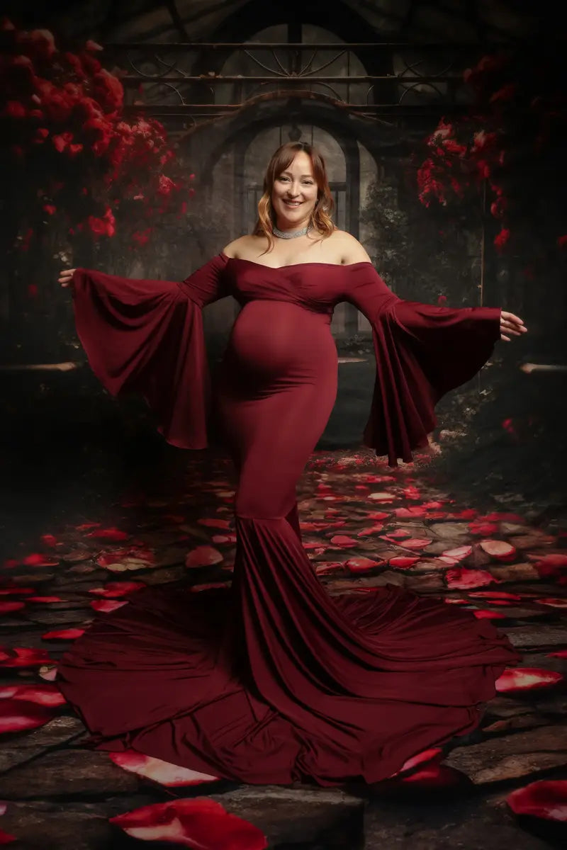 Vestido satinado maroon para sesión de fotos de maternidad con un hombro descubierto