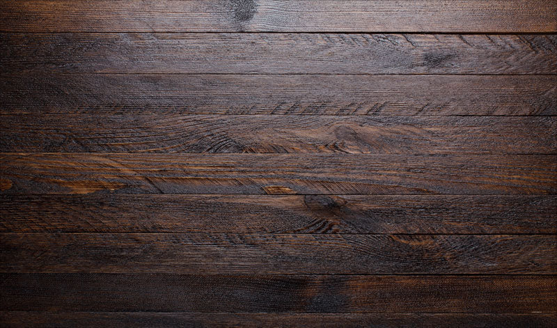 Alfombra de goma para suelos de granero de madera oscura para fotografía.